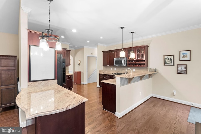 9801 Alydar Ct, Nokesville, VA 20181 - kitchen with decorative backsplash, stainless steel microwave, dark wood-style floors, and a peninsula