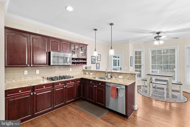 9801 Alydar Ct, Nokesville, VA 20181 - kitchen featuring appliances with stainless steel finishes, wood finished floors, a peninsula, and a sink