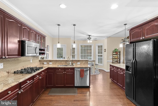 9801 Alydar Ct, Nokesville, VA 20181 - kitchen with dark wood-type flooring, ceiling fan, appliances with stainless steel finishes, a peninsula, and a sink