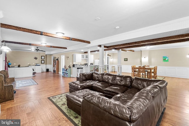 9801 Alydar Ct, Nokesville, VA 20181 - living area featuring a ceiling fan, a wainscoted wall, light wood finished floors, ornate columns, and beam ceiling
