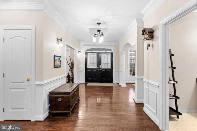 9801 Alydar Ct, Nokesville, VA 20181 - entrance foyer with arched walkways, a notable chandelier, wood finished floors, and crown molding