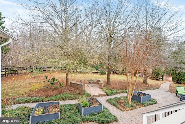 9801 Alydar Ct, Nokesville, VA 20181 - view of yard featuring fence, a vegetable garden, and a patio area