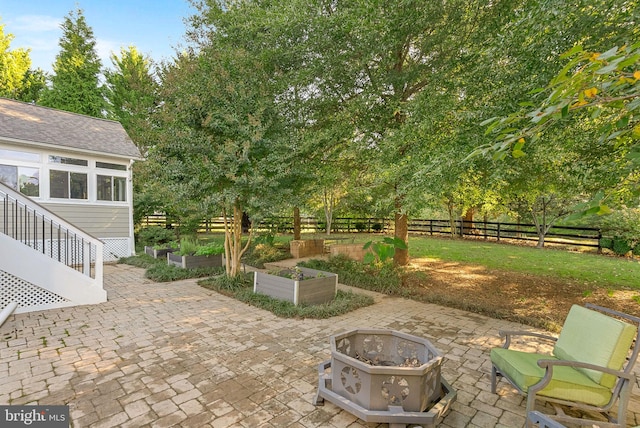 9801 Alydar Ct, Nokesville, VA 20181 - view of patio with a vegetable garden, fence, and an outdoor fire pit