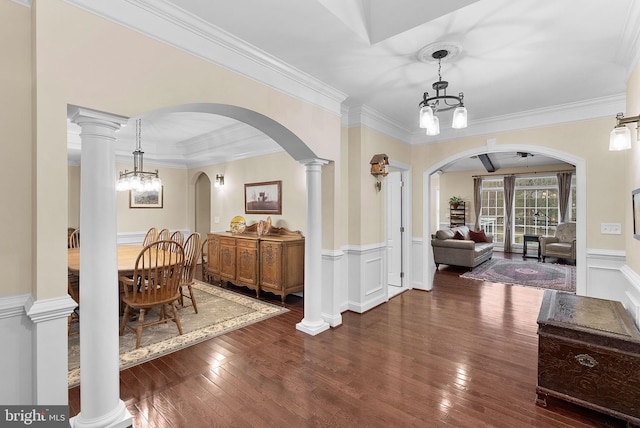 9801 Alydar Ct, Nokesville, VA 20181 - dining space with arched walkways, a notable chandelier, wainscoting, and wood-type flooring