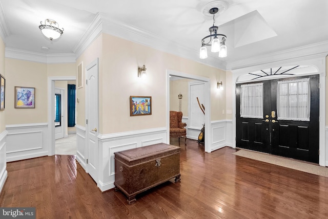 9801 Alydar Ct, Nokesville, VA 20181 - foyer entrance featuring crown molding, a notable chandelier, wood finished floors, and a wainscoted wall
