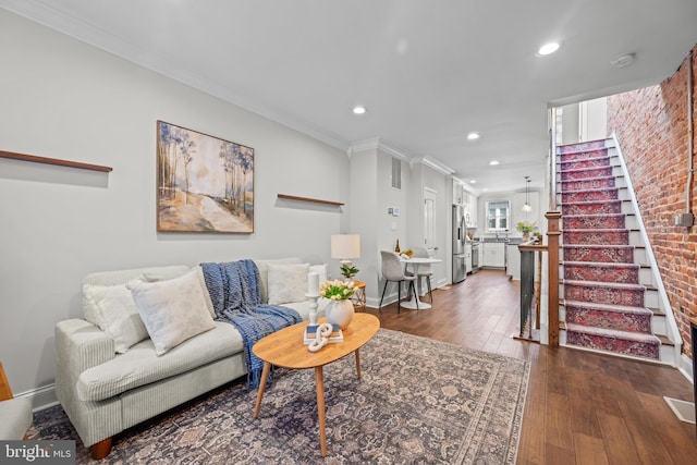 living room with baseboards, dark wood finished floors, recessed lighting, ornamental molding, and stairs