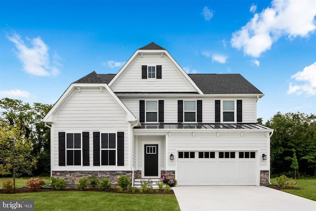 view of front of house featuring a garage and a front yard