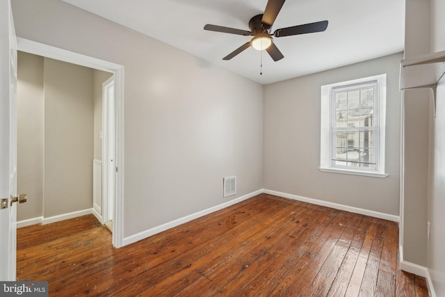 unfurnished bedroom featuring ceiling fan and dark hardwood / wood-style flooring