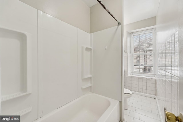 bathroom featuring toilet, tile patterned floors, and bathtub / shower combination