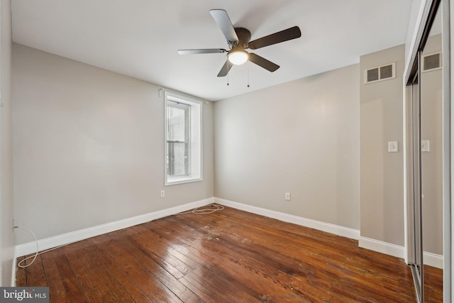 unfurnished bedroom featuring ceiling fan and dark hardwood / wood-style flooring