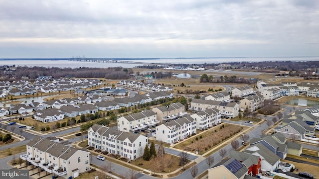 drone / aerial view with a water view and a residential view