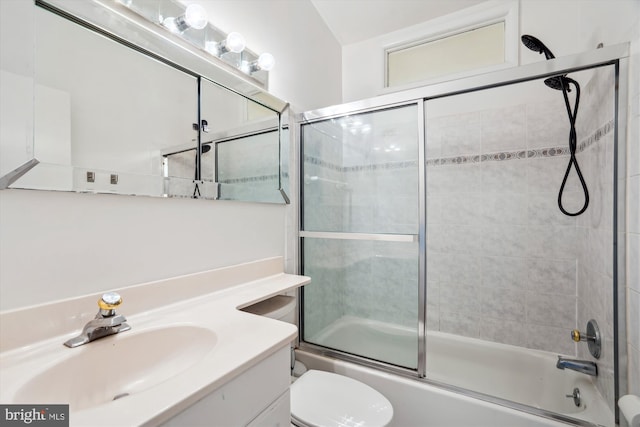 bathroom with toilet, shower / bath combination with glass door, and vanity