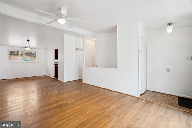 unfurnished living room with wood-type flooring, vaulted ceiling, visible vents, and ceiling fan