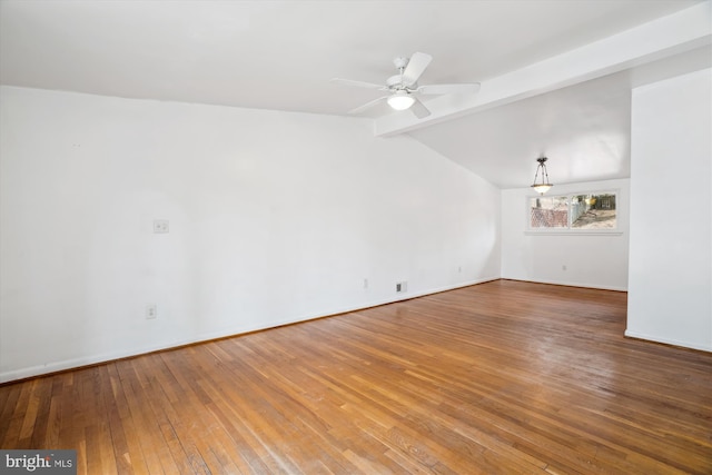 unfurnished living room with baseboards, ceiling fan, lofted ceiling with beams, and hardwood / wood-style floors