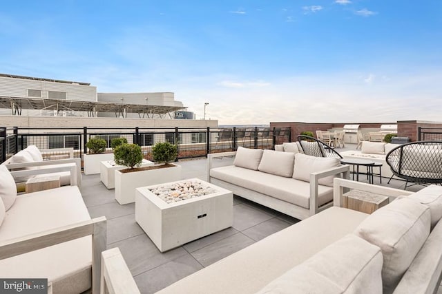 view of patio / terrace with an outdoor living space with a fire pit