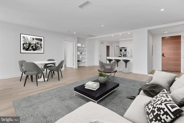 living room with light hardwood / wood-style flooring