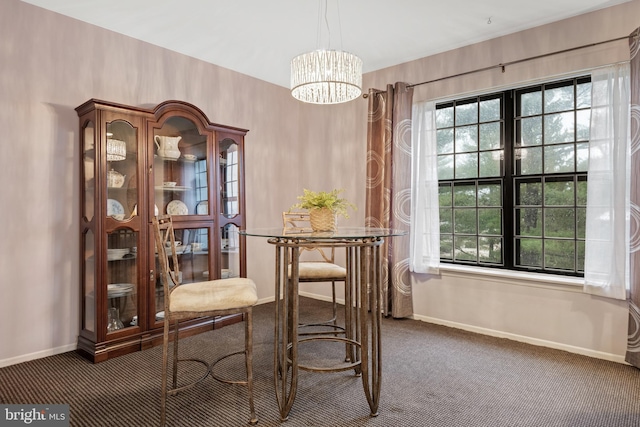 carpeted dining area featuring an inviting chandelier and baseboards