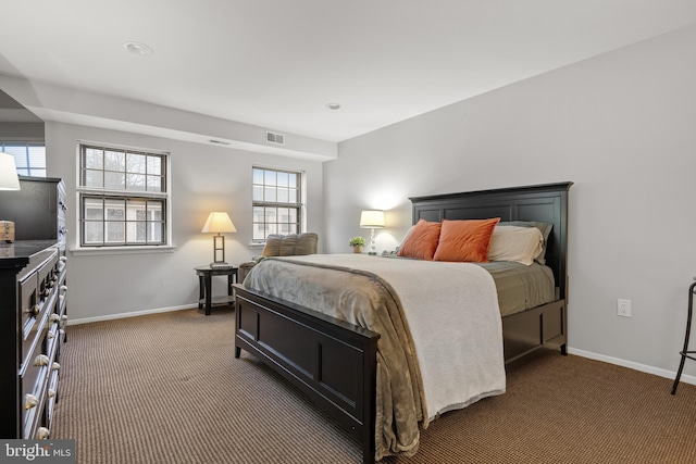 bedroom with carpet flooring, visible vents, and baseboards