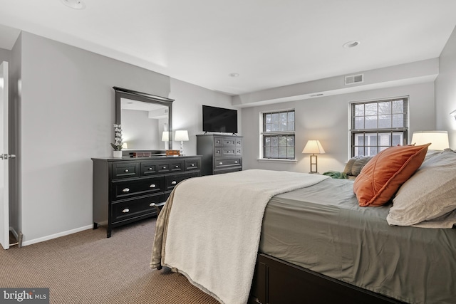 carpeted bedroom featuring visible vents and baseboards