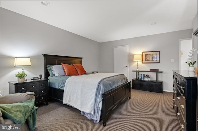 bedroom featuring baseboards and dark colored carpet