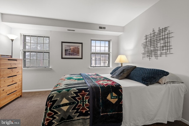 carpeted bedroom featuring visible vents and baseboards