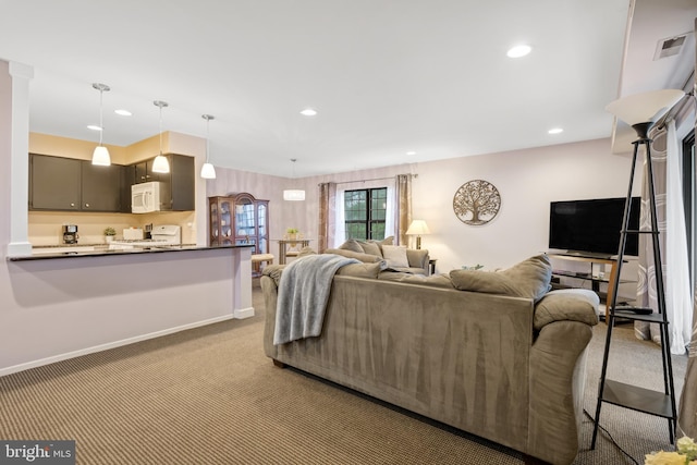 carpeted living area featuring baseboards, visible vents, and recessed lighting