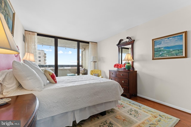 bedroom featuring baseboards and wood finished floors