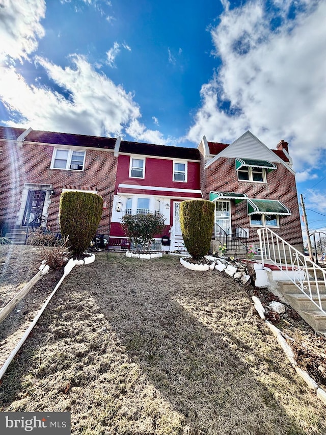 view of front of home featuring entry steps and brick siding