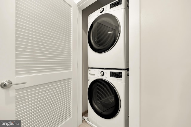 laundry room with stacked washer / drying machine