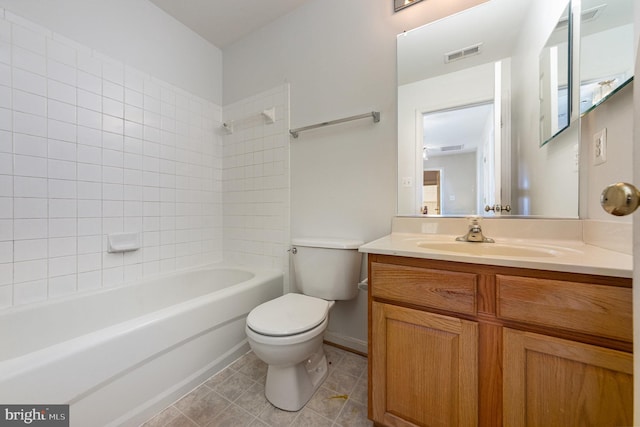 bathroom with tile patterned floors, toilet, vanity, washtub / shower combination, and visible vents