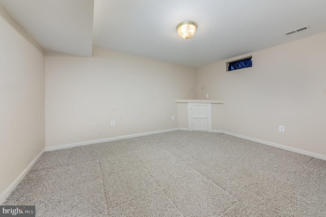 spare room with baseboards and visible vents