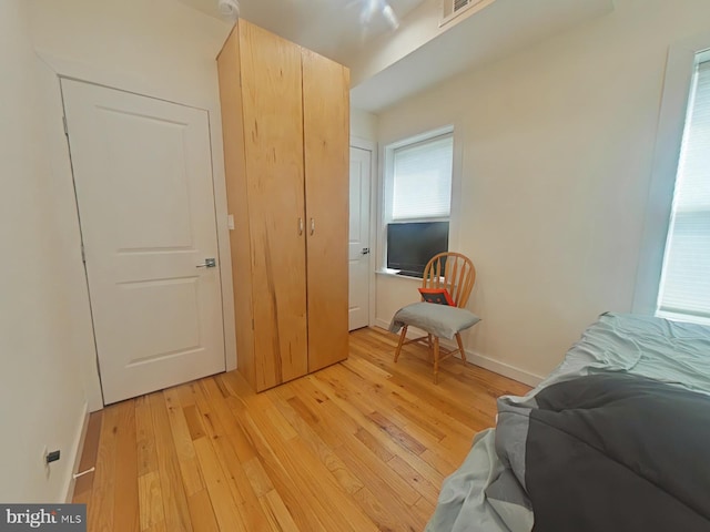 bedroom featuring light wood-style flooring and baseboards