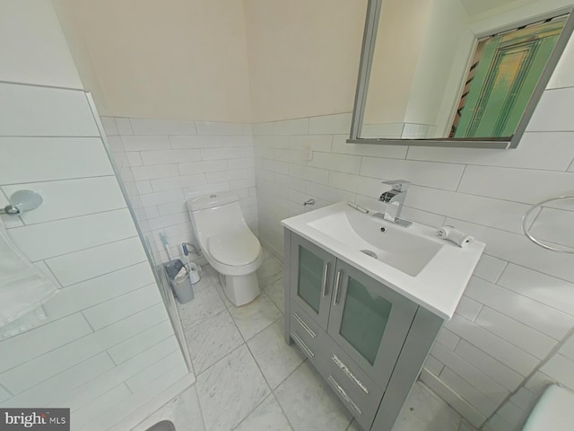 bathroom featuring toilet, tile walls, and vanity