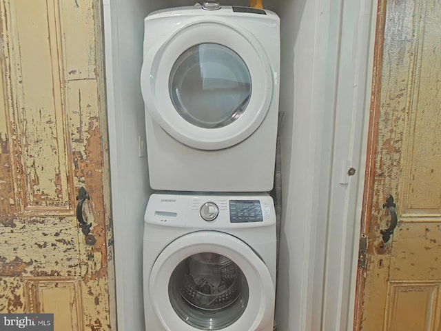 clothes washing area featuring stacked washer / drying machine