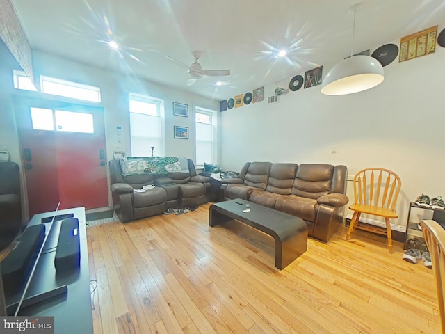 living area with visible vents, ceiling fan, and hardwood / wood-style flooring