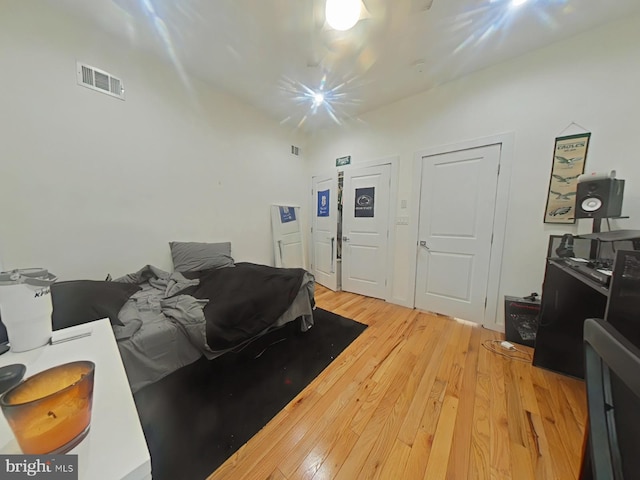 bedroom featuring light wood-type flooring and visible vents