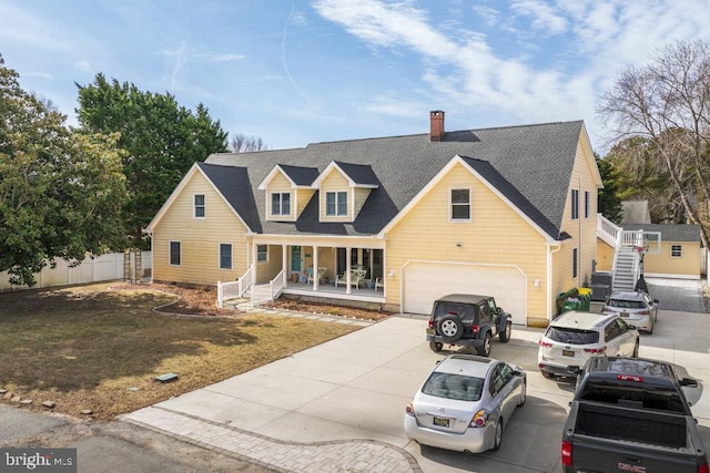 view of front of home featuring covered porch, a garage, a shingled roof, fence, and concrete driveway