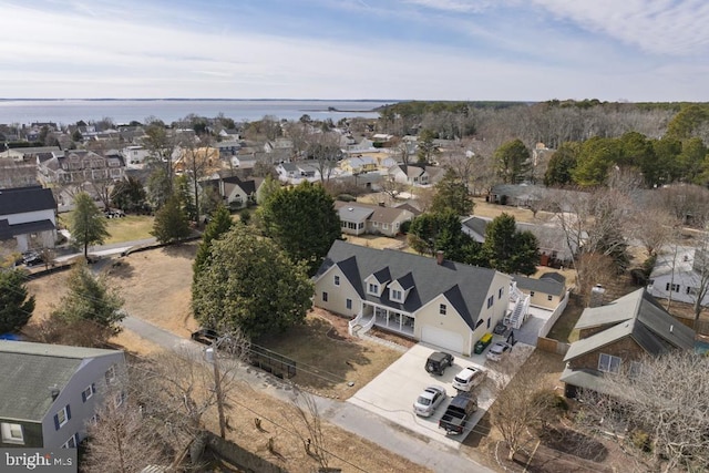 birds eye view of property with a residential view and a water view