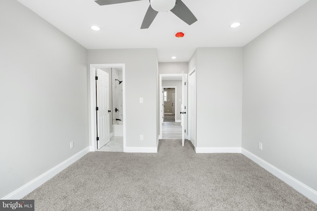 unfurnished bedroom with recessed lighting, a ceiling fan, light carpet, ensuite bath, and baseboards