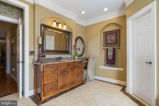 bathroom featuring ornamental molding, recessed lighting, vanity, and baseboards