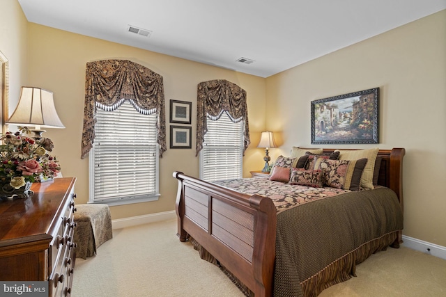 bedroom featuring light carpet, visible vents, and baseboards