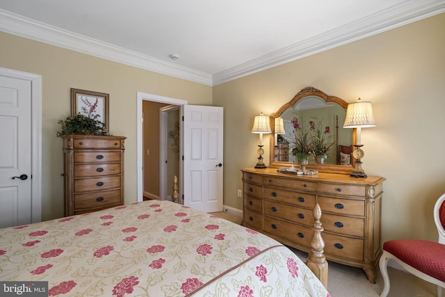 bedroom with ornamental molding and carpet