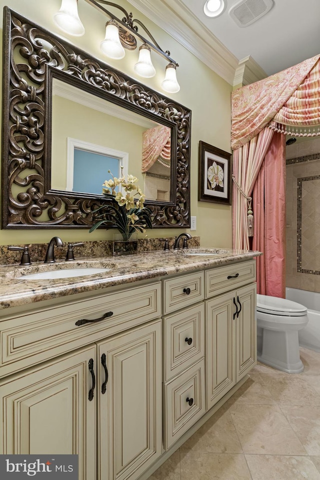 full bath featuring double vanity, ornamental molding, a sink, and toilet