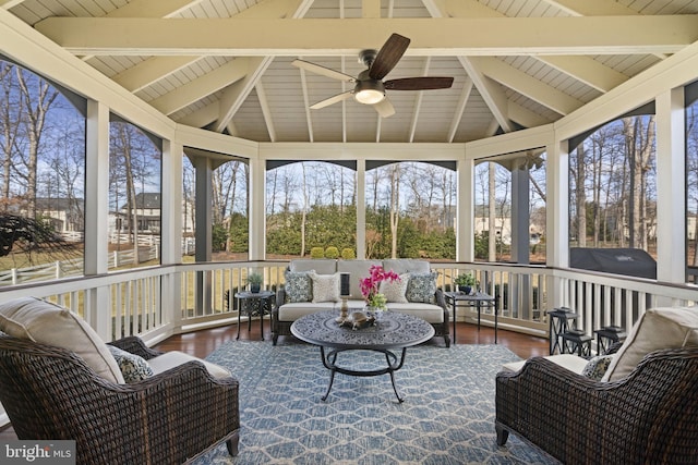 sunroom featuring a ceiling fan, wood ceiling, and lofted ceiling with beams