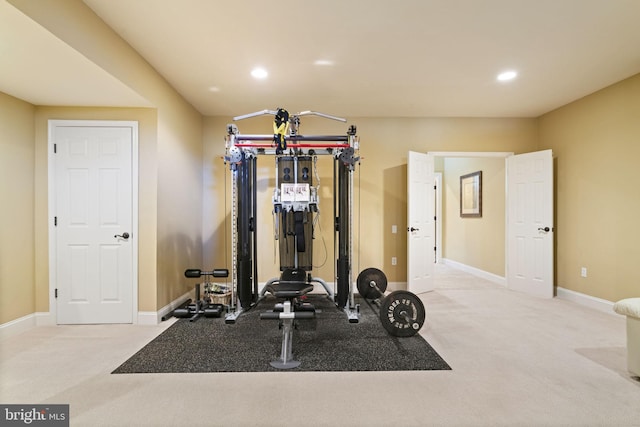 workout area with light carpet, baseboards, and recessed lighting