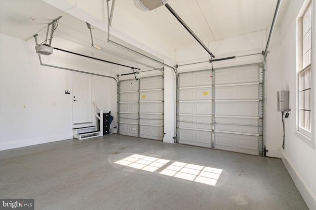 garage with baseboards and a garage door opener