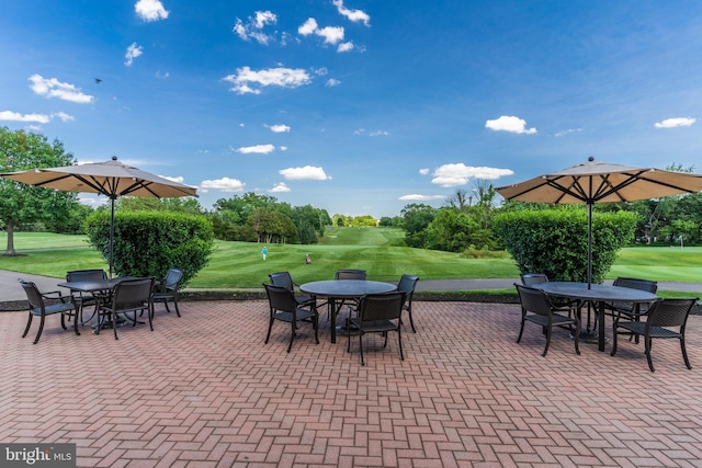 view of patio with outdoor dining space and golf course view