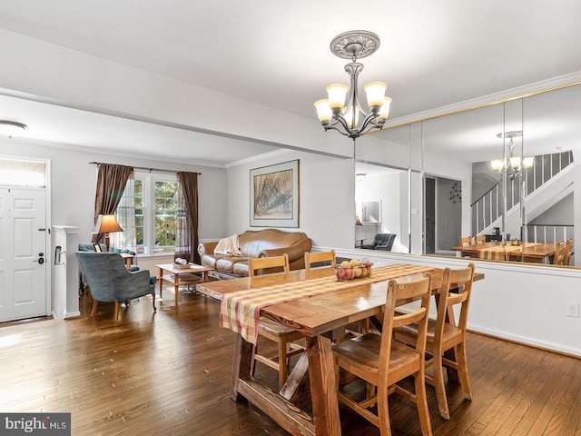 dining area with crown molding, baseboards, stairs, a notable chandelier, and wood-type flooring