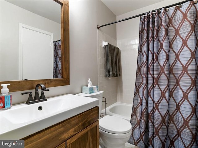 bathroom with vanity, shower / bath combination with curtain, and toilet