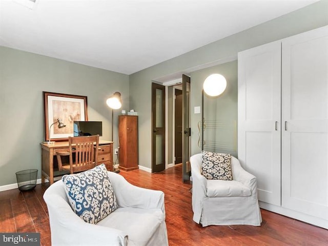 interior space featuring baseboards and wood finished floors